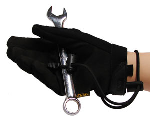 A bungee cord style wrist lanyard is attached to a tool being held by a gloved hand