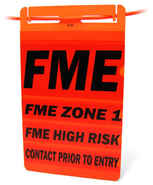 A bright orange sign with four inserts filled with instructions for FME zones