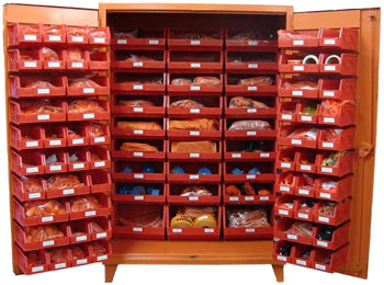 A large orange cabinet stocked with a large variety of foreign material exclusion supplies
