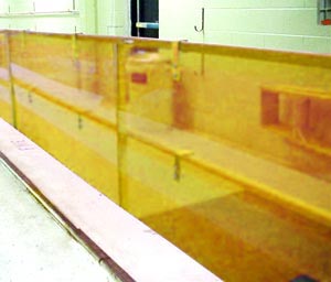 A handrail is lined with a tough orange plastic-like sheeting