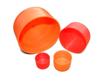 Various size cylindrical plastic pieces meant for capping the ends of pipe