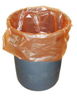 An orange trash bag sits in a trash can