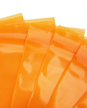 A fanned group of orange tinted zip lock bags