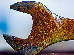 A closeup of a rusty crescent wrench